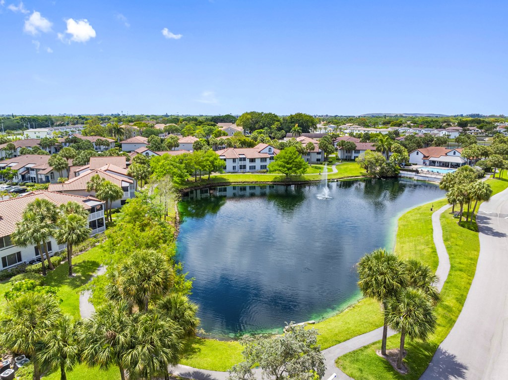 A lake surrounded by houses and trees.